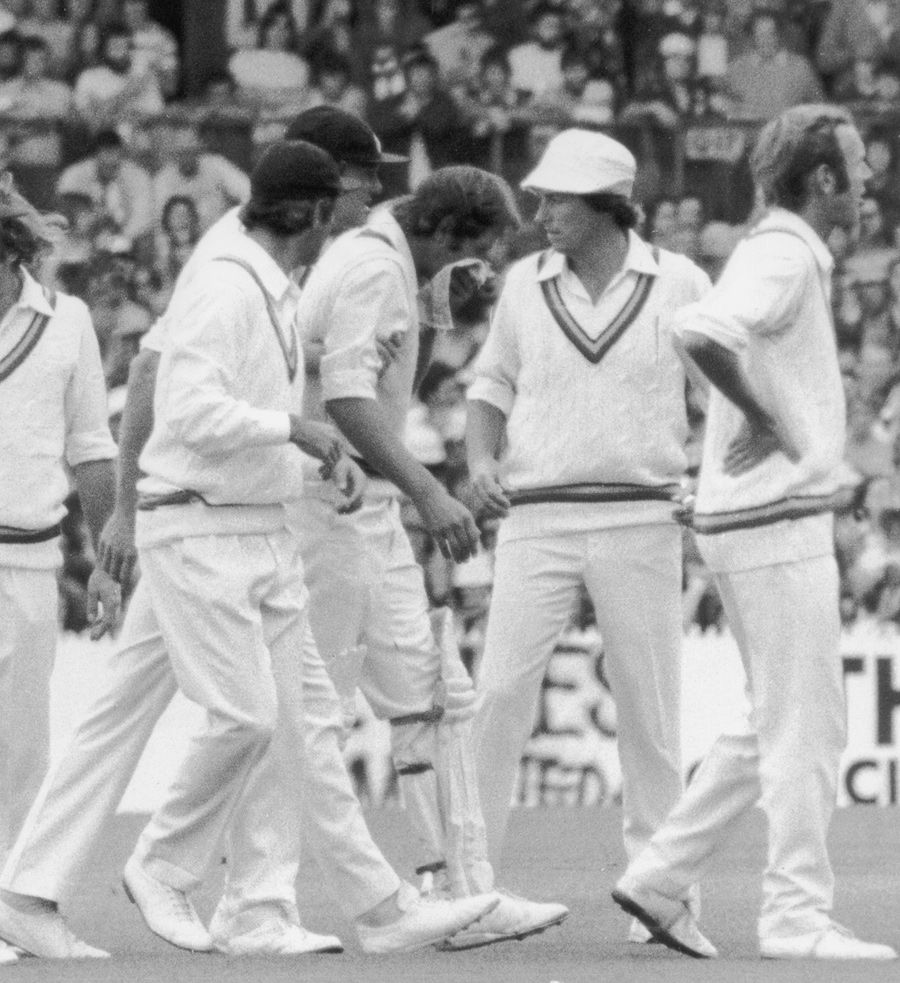 The England players gather around Rick McCosker who broke his jaw