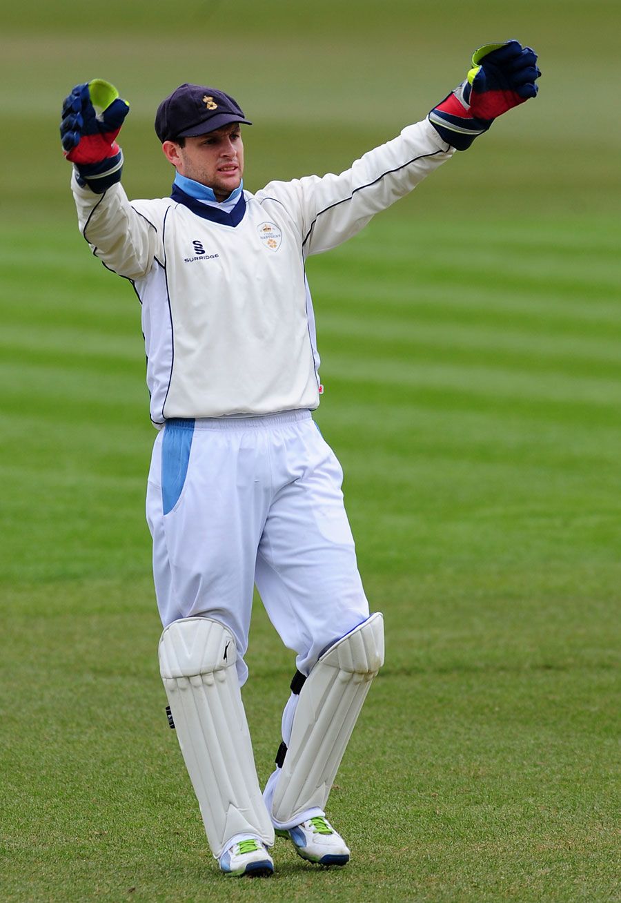 Tom Poynton directs behind the stumps