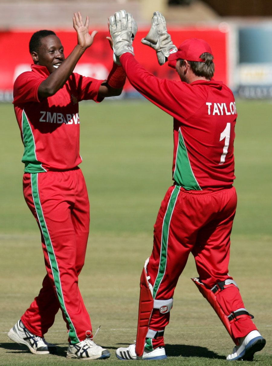 Shingi Masakadza celebrates a wicket with Brendan Taylor