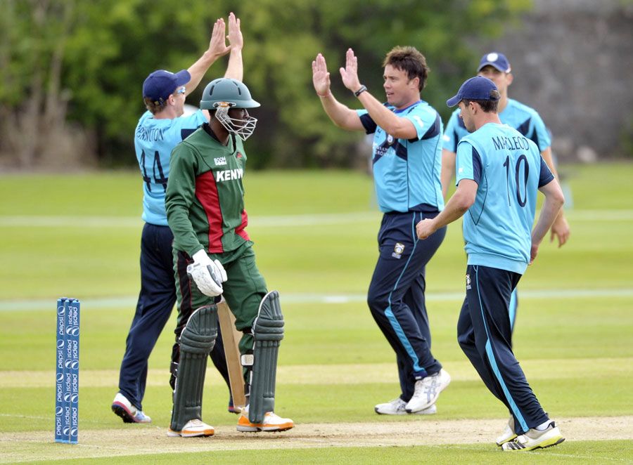 Neil Carter celebrates with team-mates after dismissing Alex Obanda
