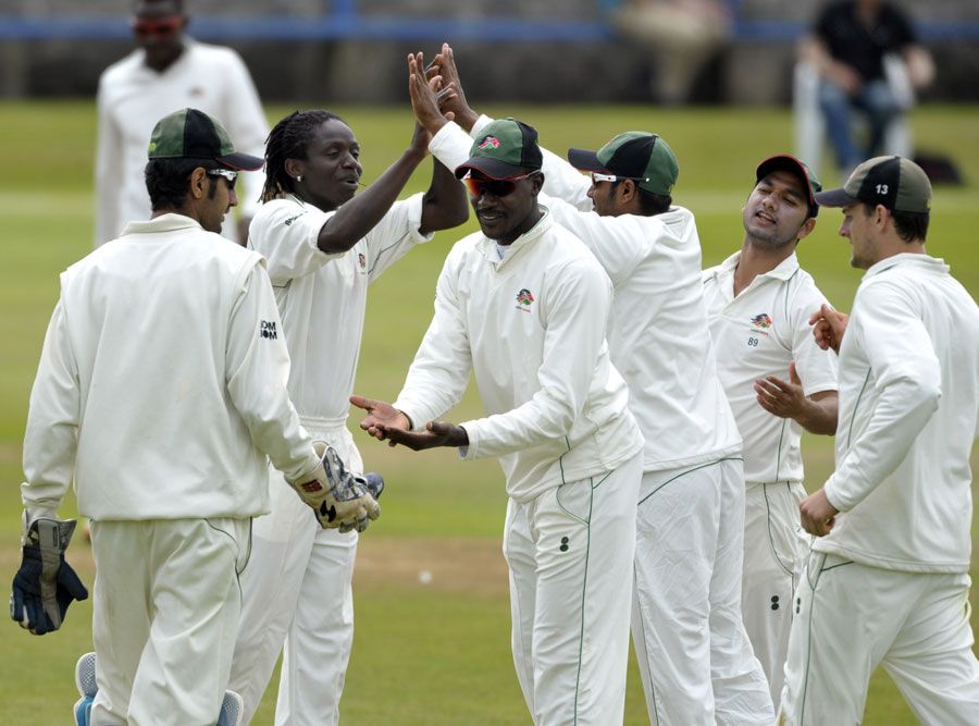 Nehemiah Odhiambo (second from left) celebrates a wicket
