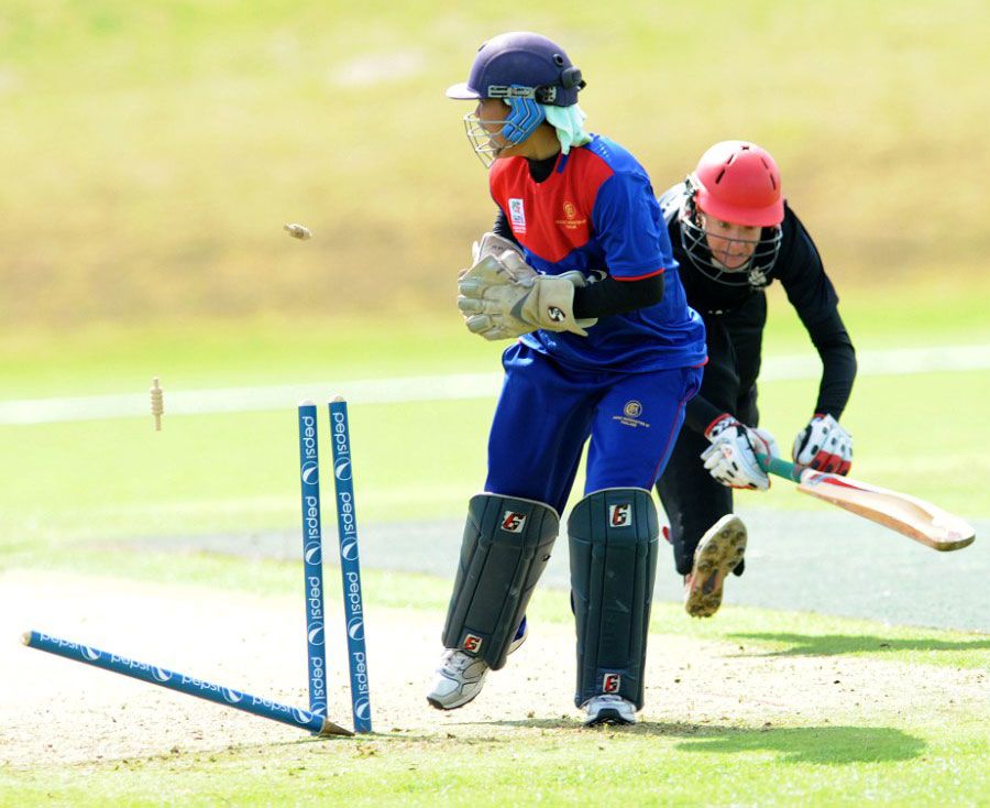 Thailand wicketkeeper Pundarika Prathanmitr runs out Canada's Sheryl Tittlemier