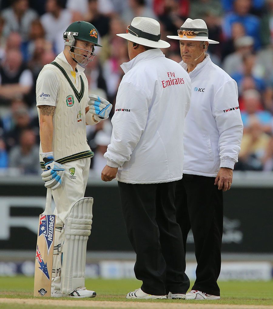 Michael Clarke chats animatedly with the umpires