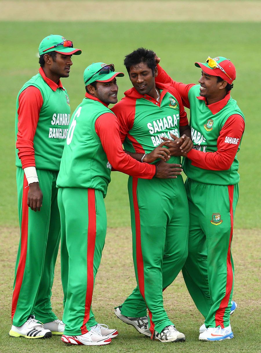 Robiul Islam is congratulated on taking a wicket
