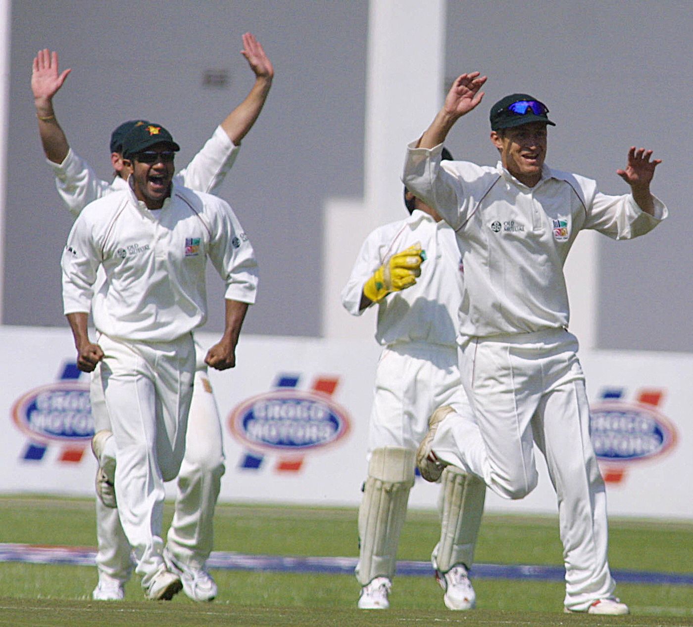 Dion Ebrahim and Trevor Gripper celebrate the dismissal of Hamish Marshall