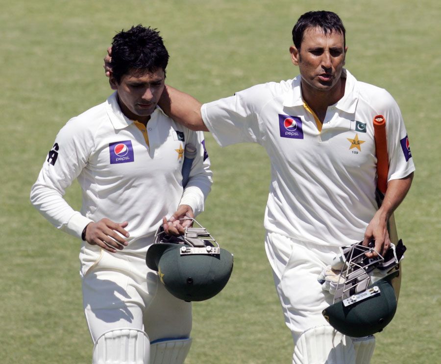 Younis Khan and Adnan Akmal walk off the pitch for the lunch break