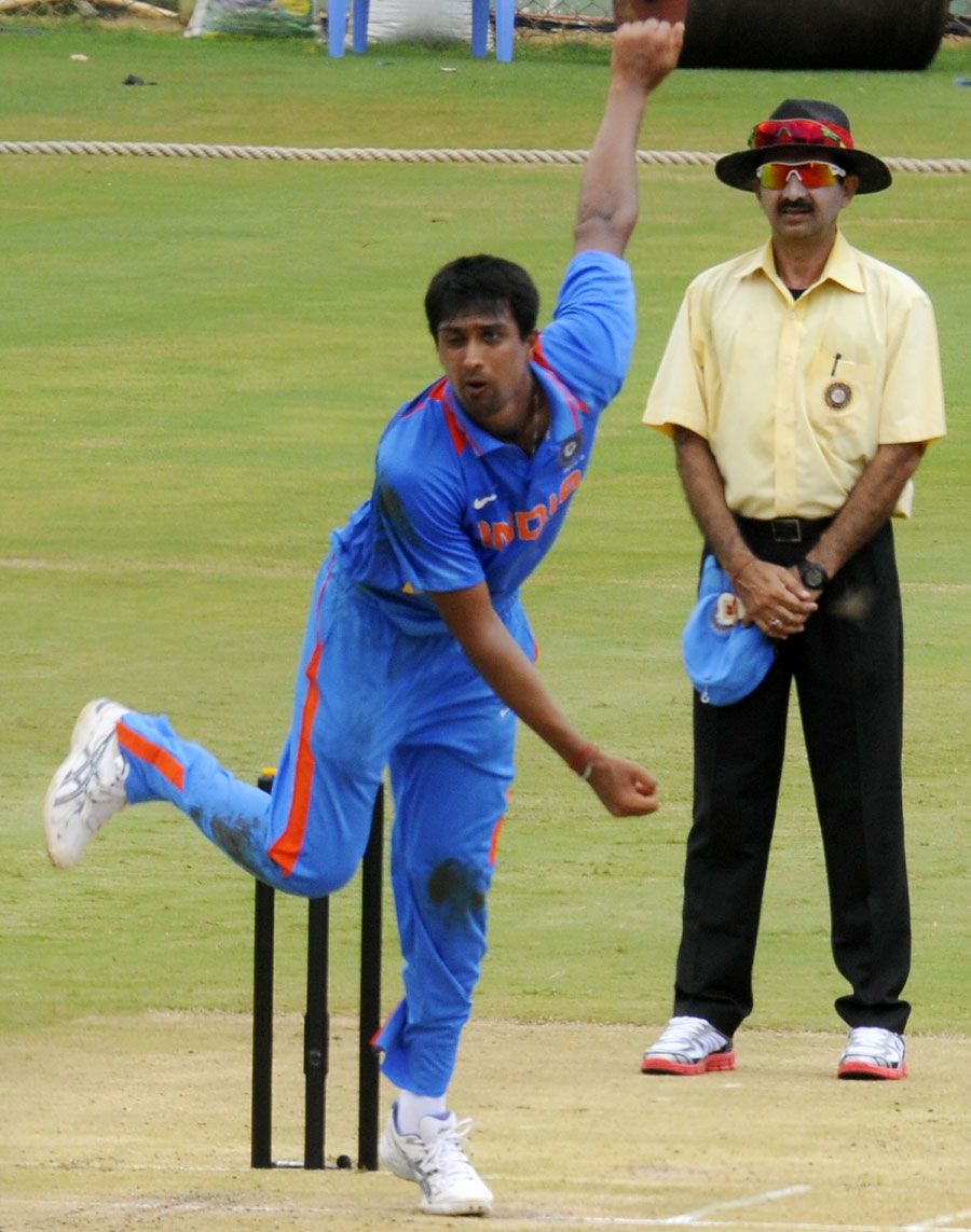Rahul Sharma bowls against New Zealand A