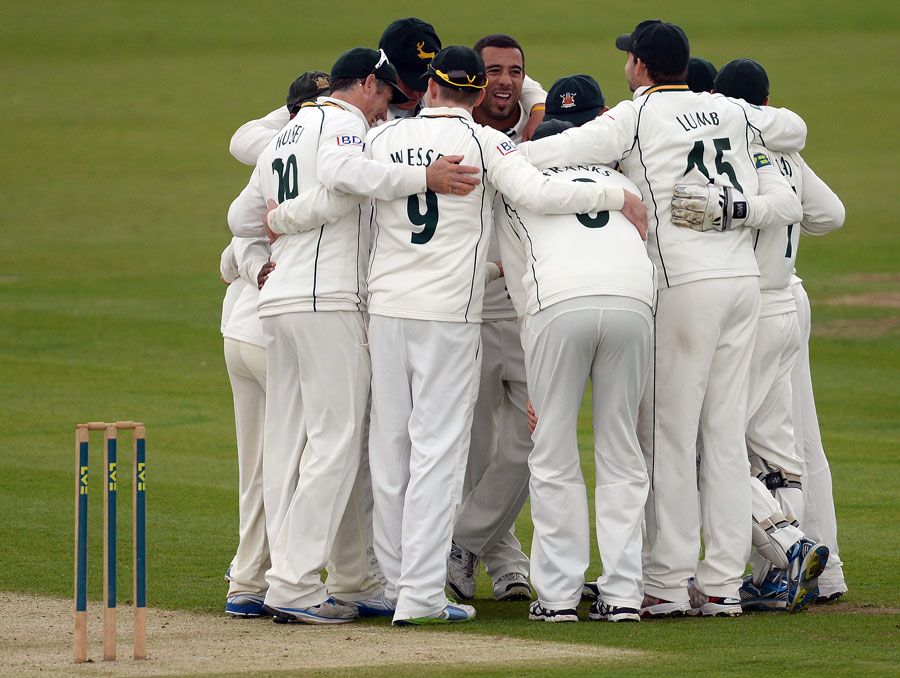 Andre Adams is at the centre of a celebratory huddle