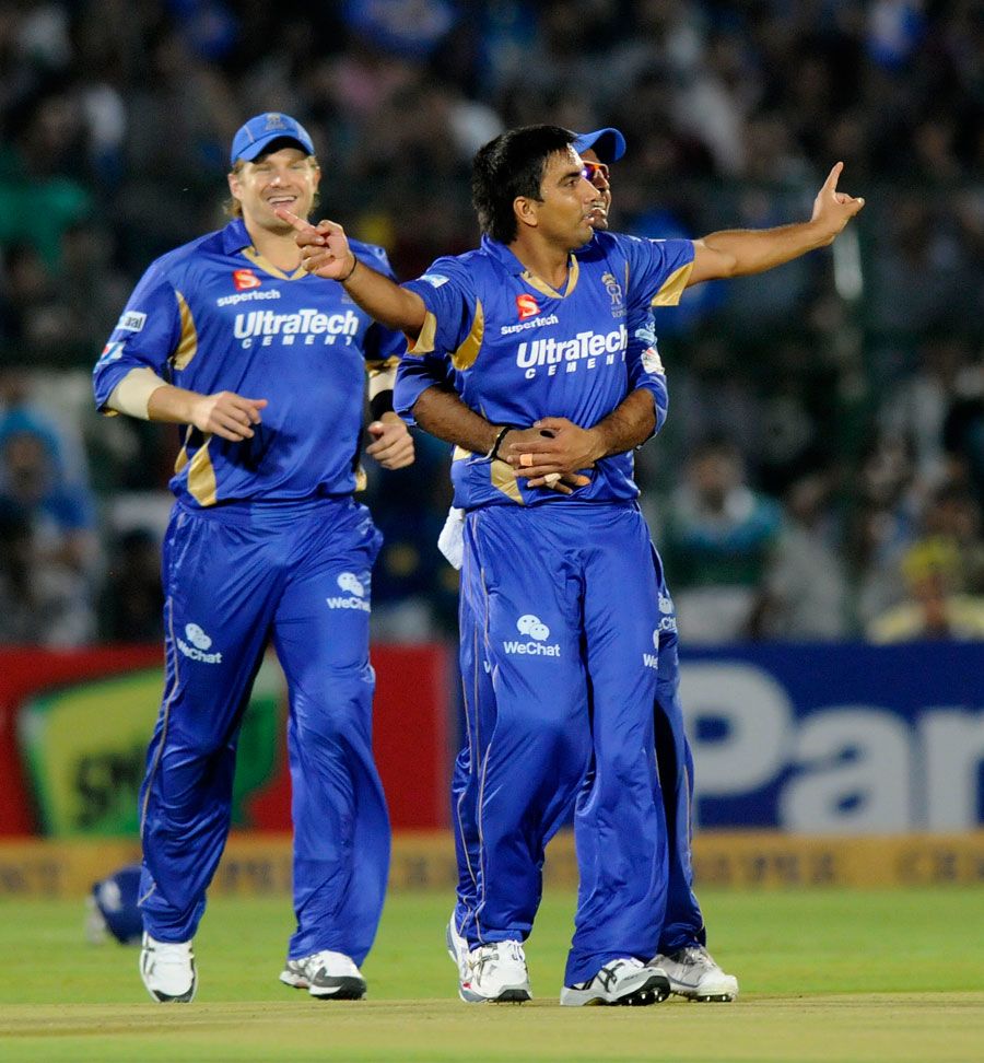 Vikramjeet Malik is embraced by team-mates after removing Dwayne Smith