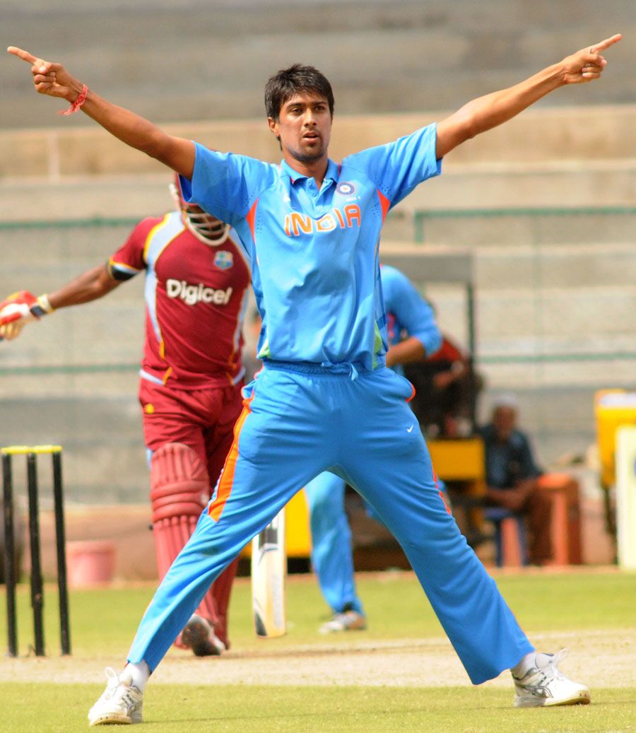 Rahul Sharma strikes a pose after knocking over another batsman