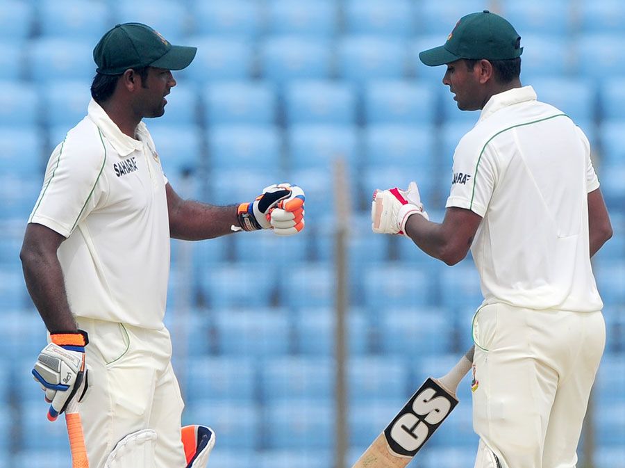 Robiul Islam and Sohag Gazi bump fists during their 105-run partnership