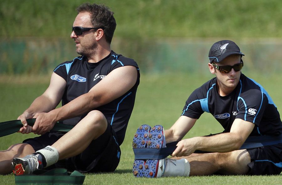 Kane Williamson and Mark Gillespie stretch during training