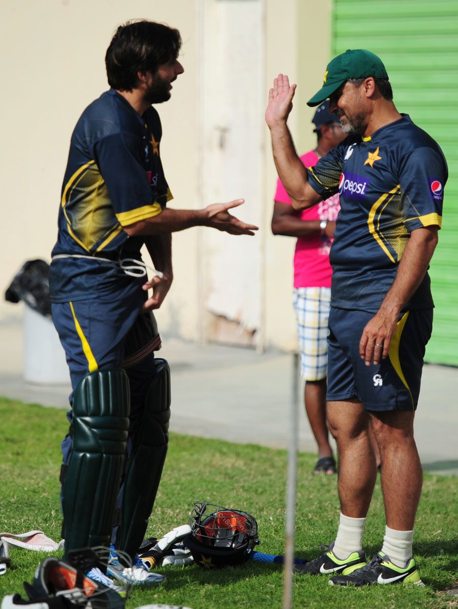 Shahid Afridi and team manager Moin Khan share a lighter moment during training