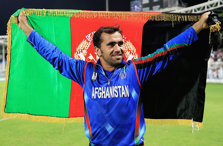Karim Sadiq holds the Afghanistan flag after beating Nepal