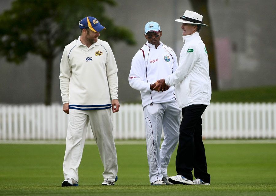 Shivnarine Chanderpaul and Aaron Redmond talk to Billy Bowden in between overs