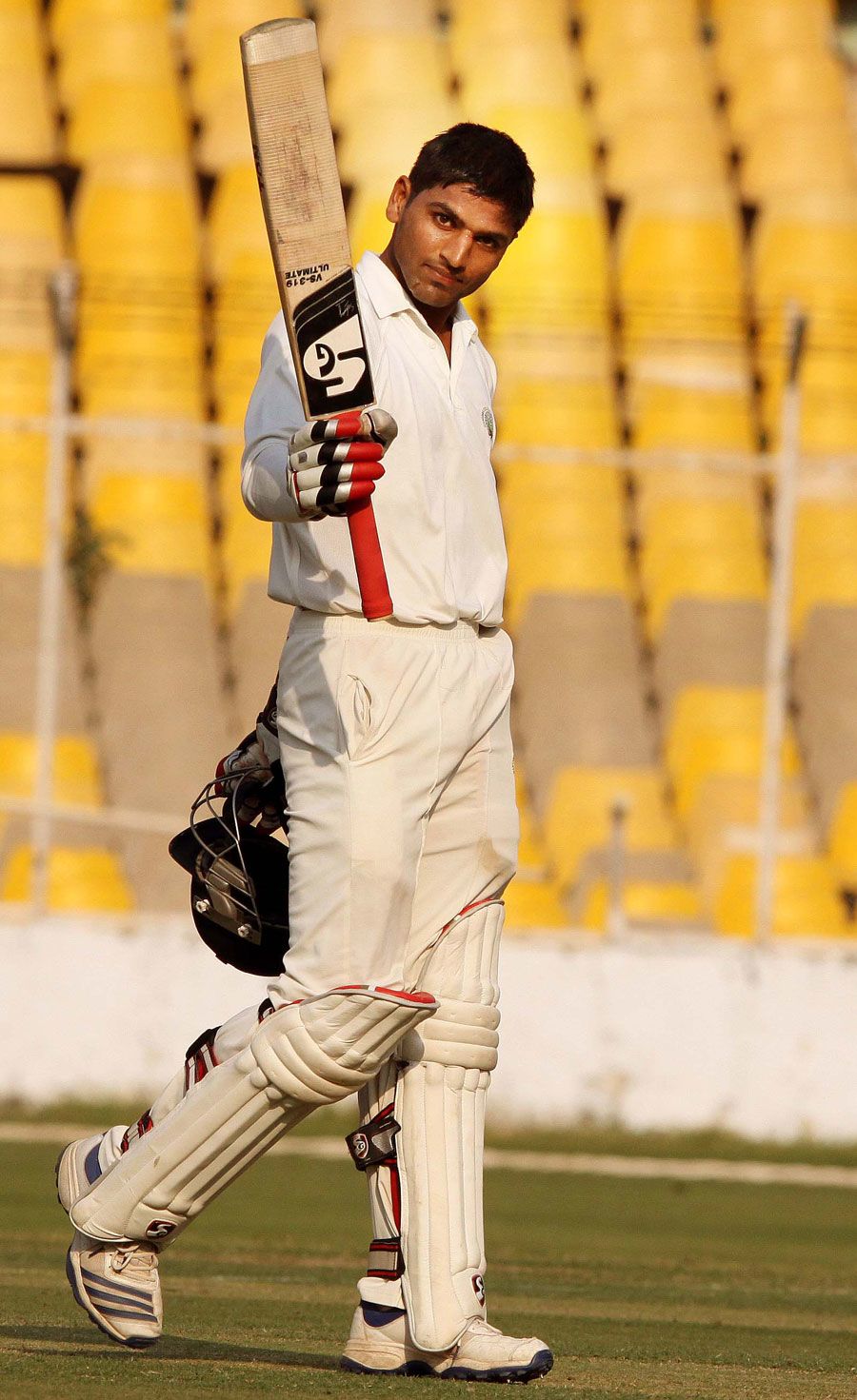Nitin Saini sneaks a look at the camera after reaching a century