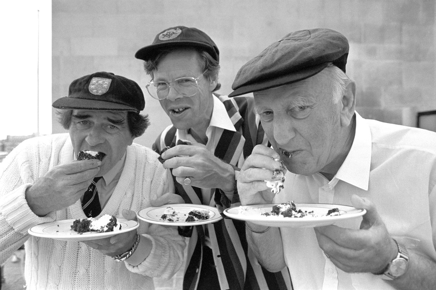 BBC commentators Fred Trueman, Christopher Martin-Jenkins and Brian Johnston eat cake
