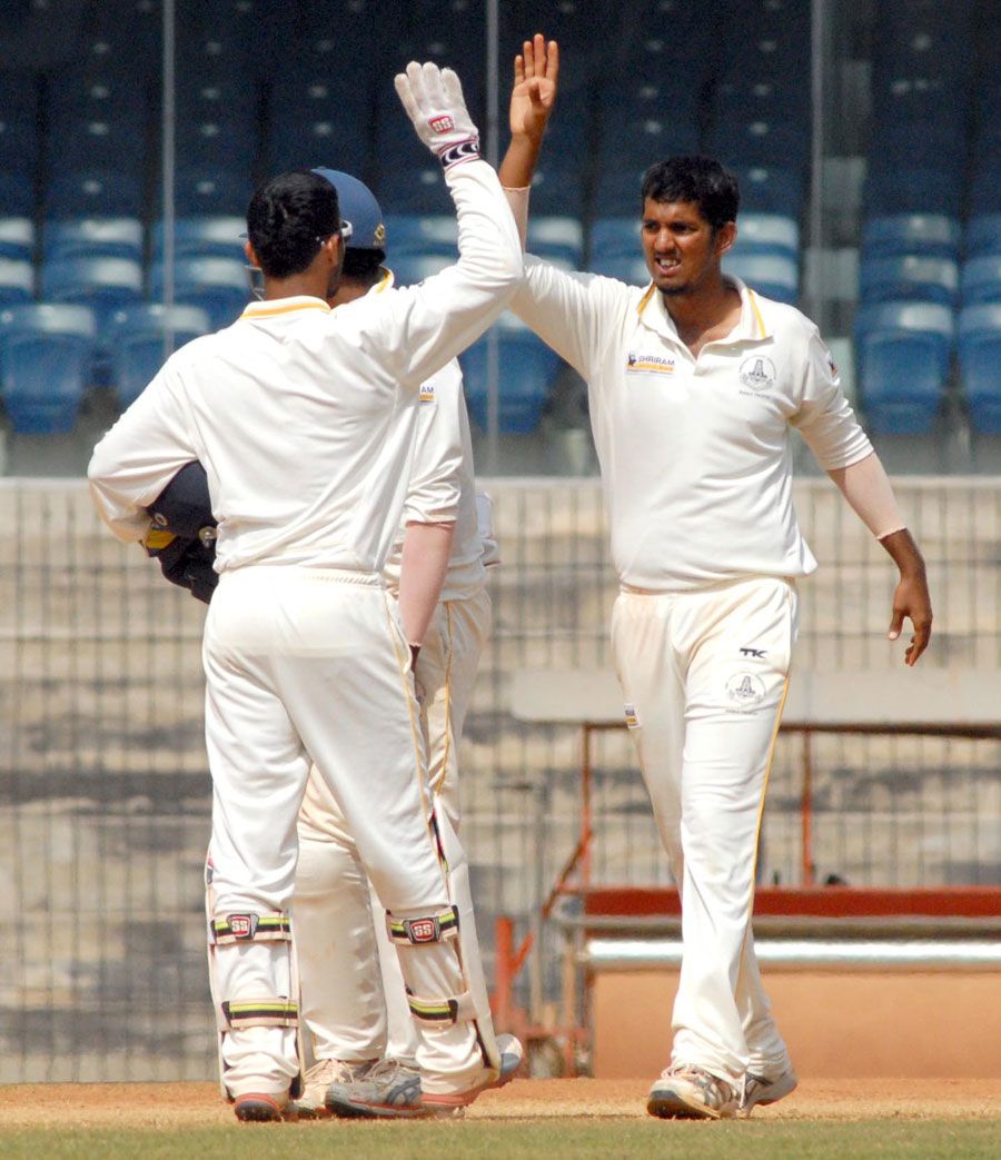 Malolan Rangarajan celebrates a wicket with his team-mates