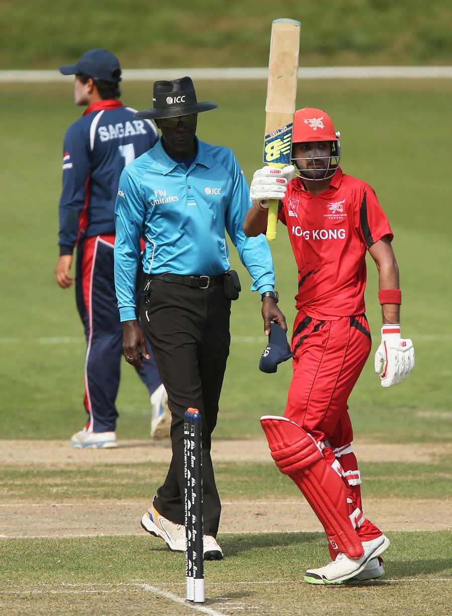 Waqas Barkat raises his bat after scoring fifty