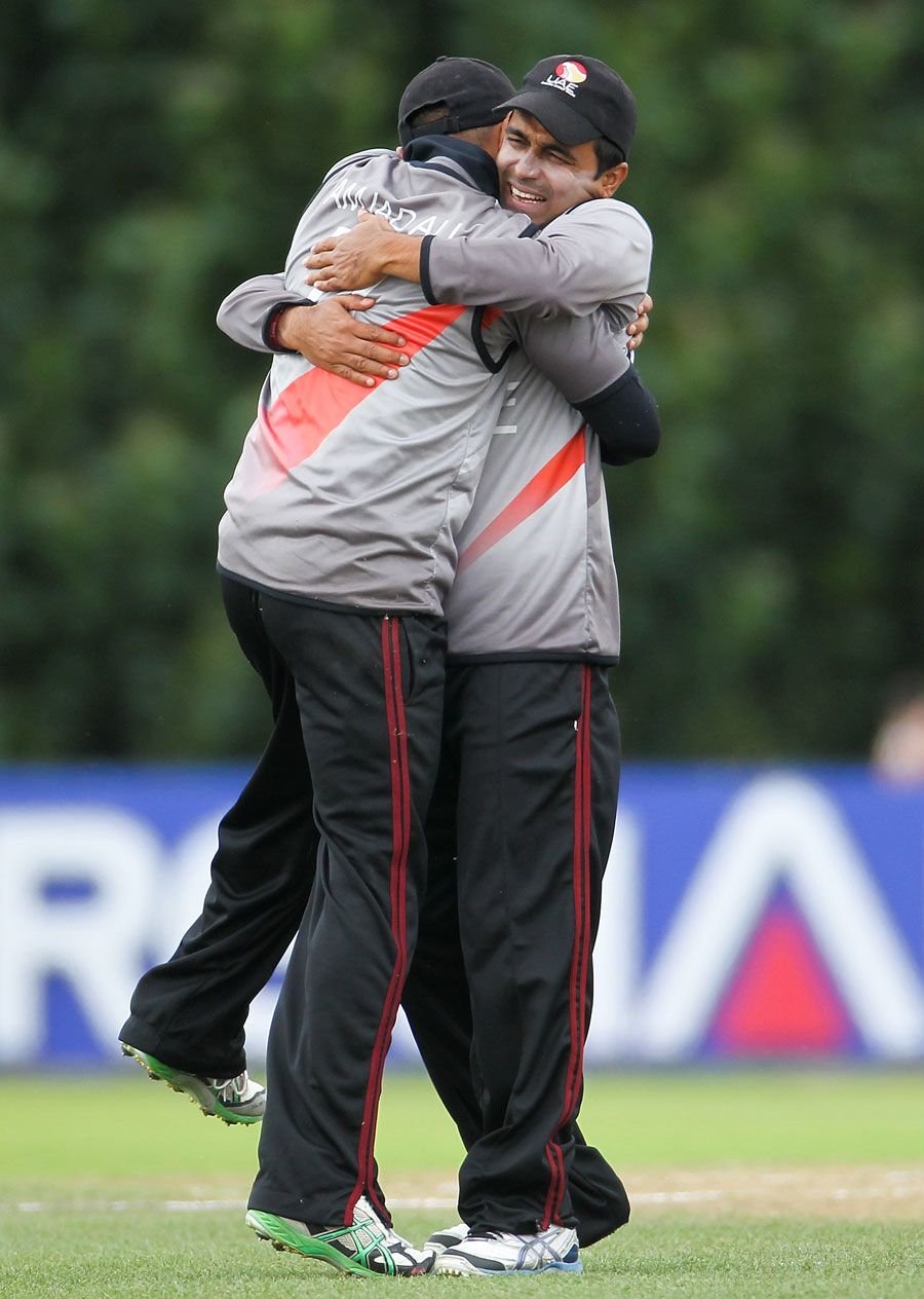 Amjad Ali is hugged by his captain Khurram Khan after taking a catch
