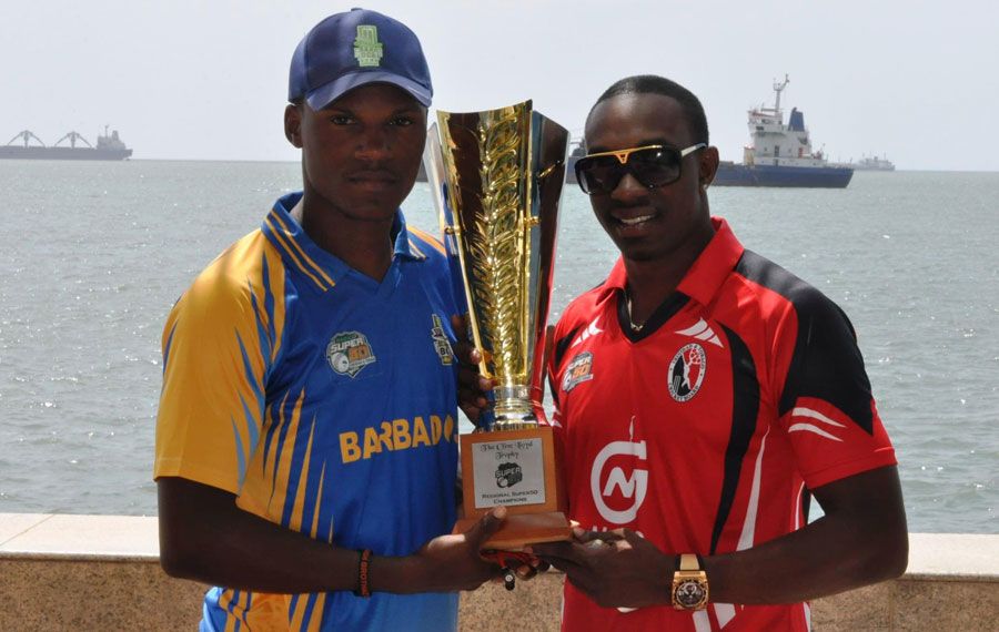 Dwayne Bravo and Kevin Stoute pose with the tournament trophy