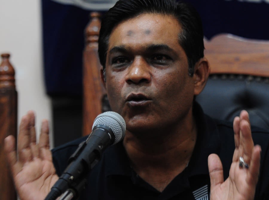 Rashid Latif gestures during a press conference