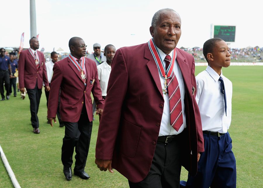 Andy Roberts leads Richie Richardson and Curtly Ambrose in a parade after they were knighted