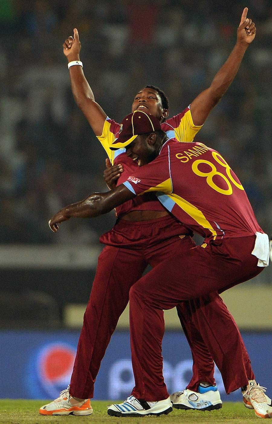 Darren Sammy hugs Krishmar Santokie, who had Ahmed Shehzad lbw first ball