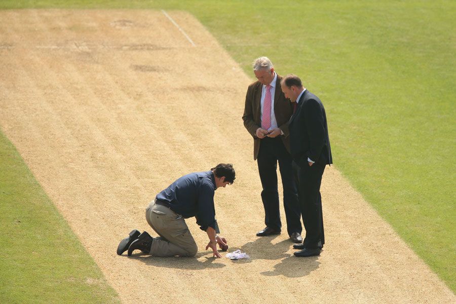 Tony Pigott and David Capel inspect the pitch