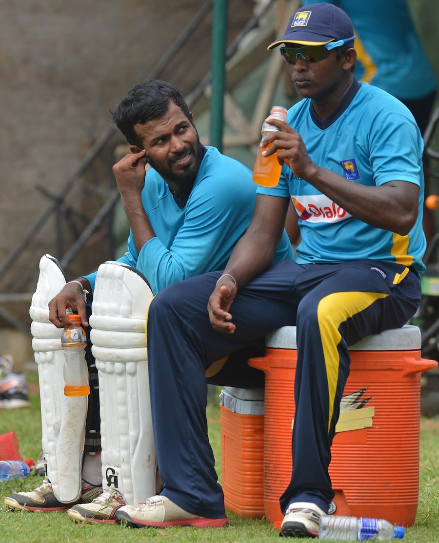Ajantha Mendis and Upul Tharanga take a breather during training