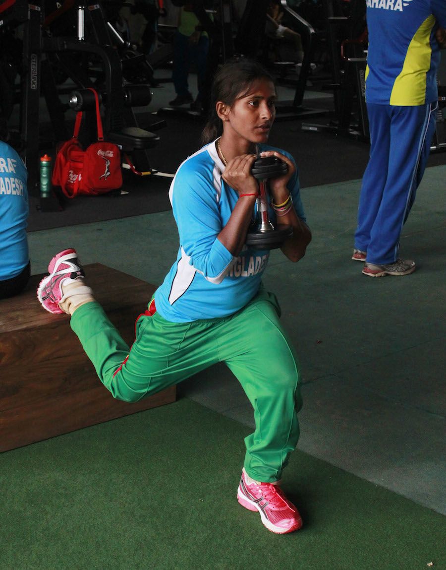 Lata Mondal stretches with a dumbbell