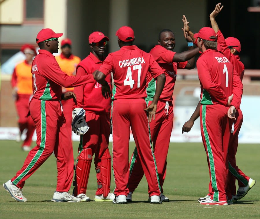 John Nyumbu is congratulated after picking a wicket