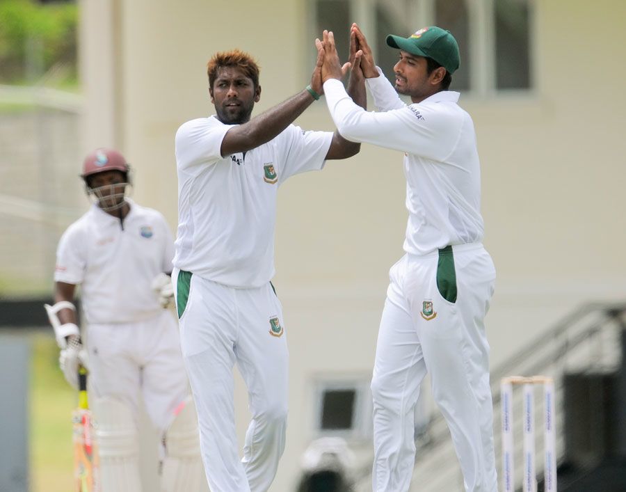 Robiul Islam celebrates snaring one with a team-mate
