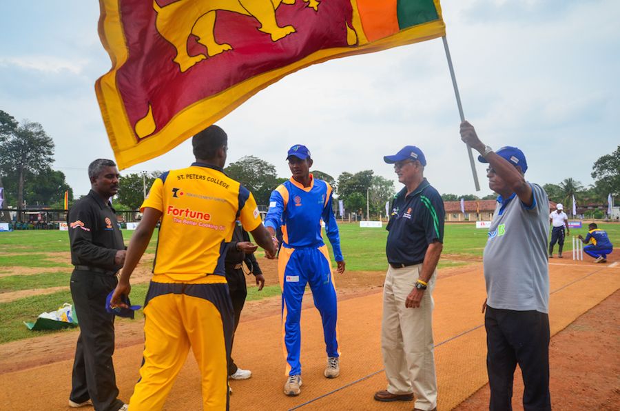 Michael Tissera (second from right) looks on during the toss