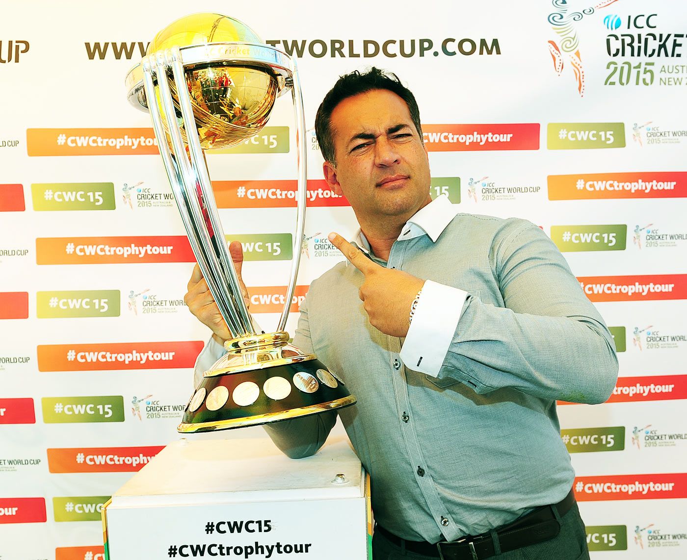 Former England captain Adam Hollioake poses with the World Cup trophy
