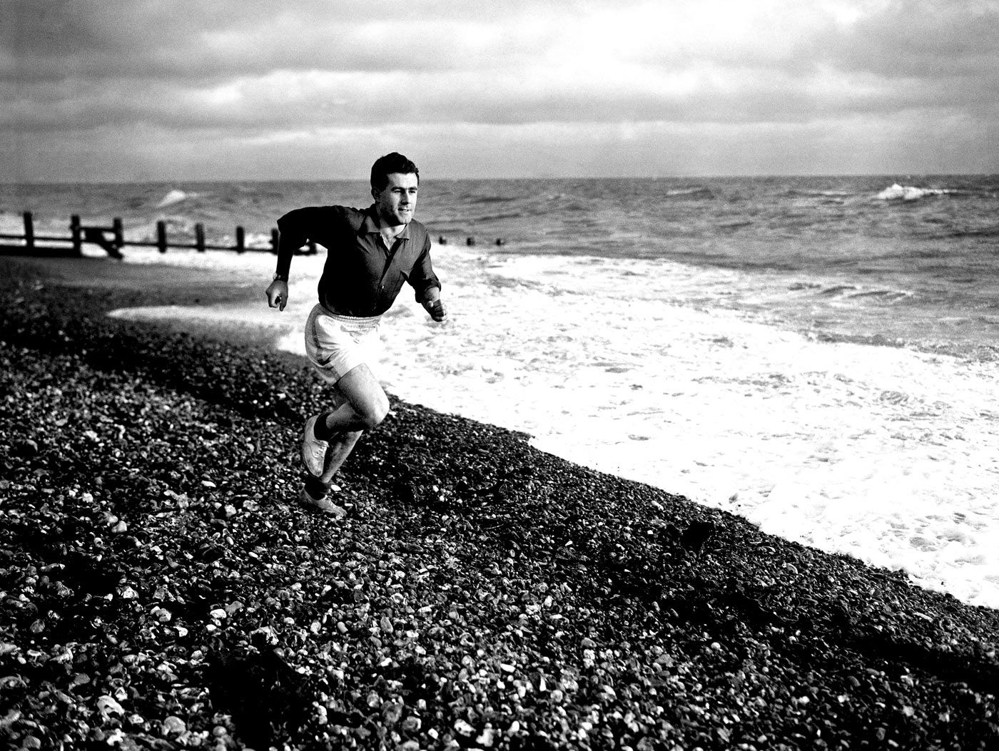 Ken Suttle runs on a shingled beach in Worthing