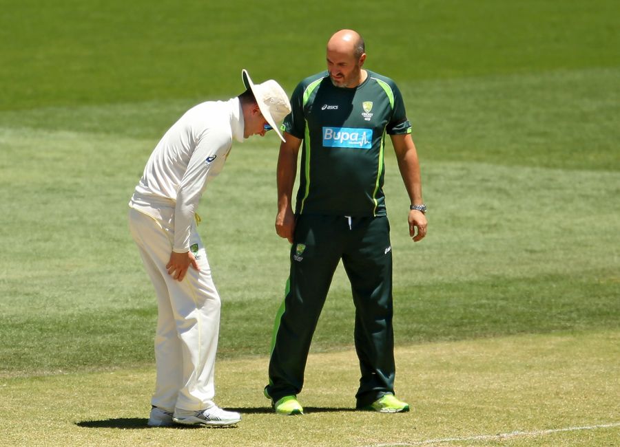 Michael Clarke speaks to physio Alex Kountouris about his hamstring