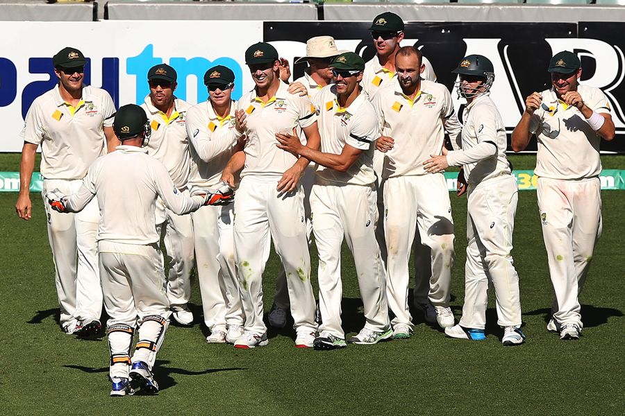 Australia gather around Mitch Marsh after he completes the catch to dismiss Virat Kohli