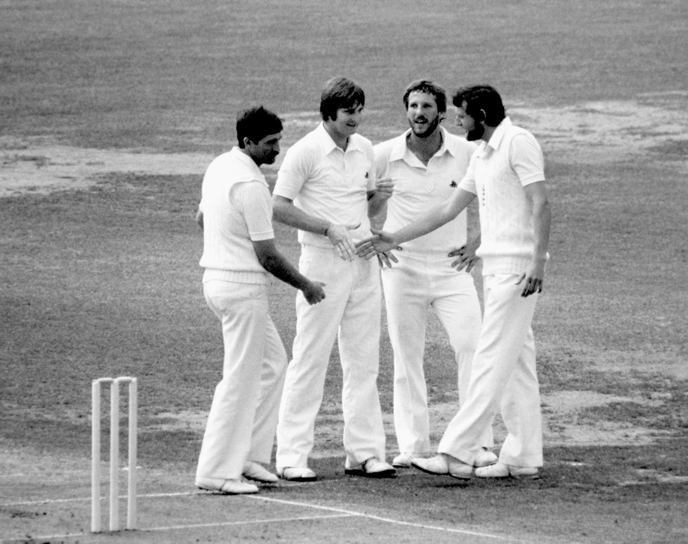 Mike Hendricks, Ian Botham and Graham Gooch congratulate Chris Old