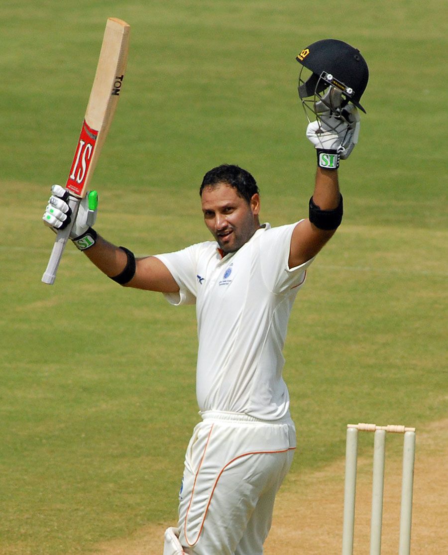 Devendra Bundela raises his bat after scoring his 24th first-class century