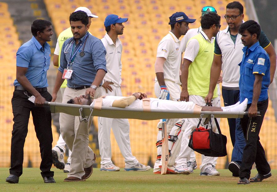 Rohan Bhosale is stretchered off the field