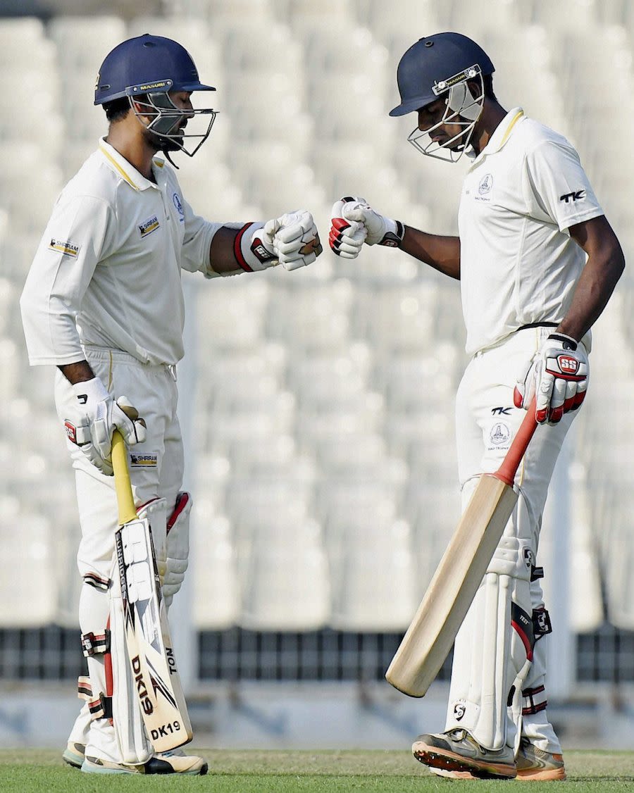 Dinesh Karthik is congratulated for his fifty by R Prasanna