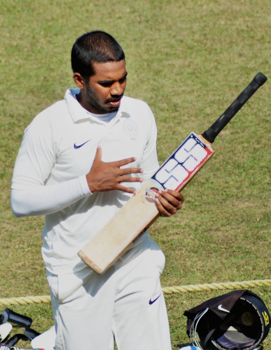 Akshath Reddy walks back after scoring a hundred