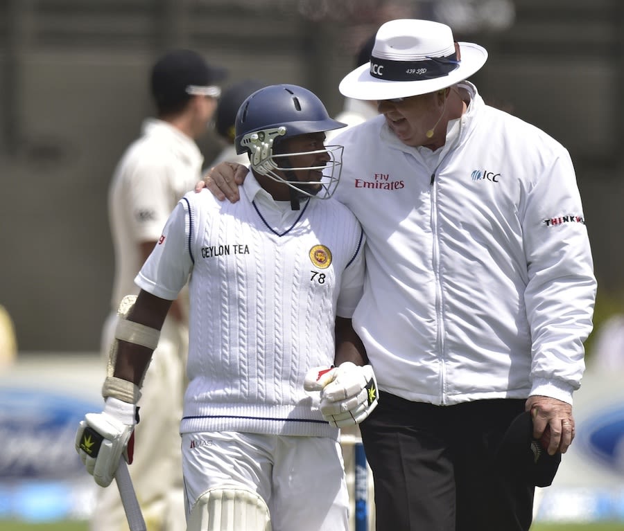 Umpire Steve Davis has a chat with Rangana Herath
