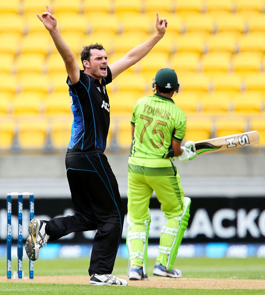 A jubilant Kyle Mills wheels away after trapping Younis Khan lbw