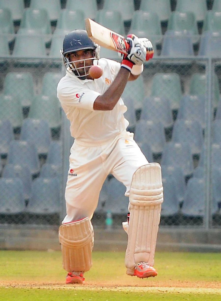 Karnataka's R Samarth drives down the ground