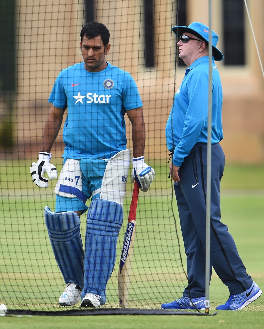 MS Dhoni gets ready for a hit in the nets as Duncan Fletcher looks on