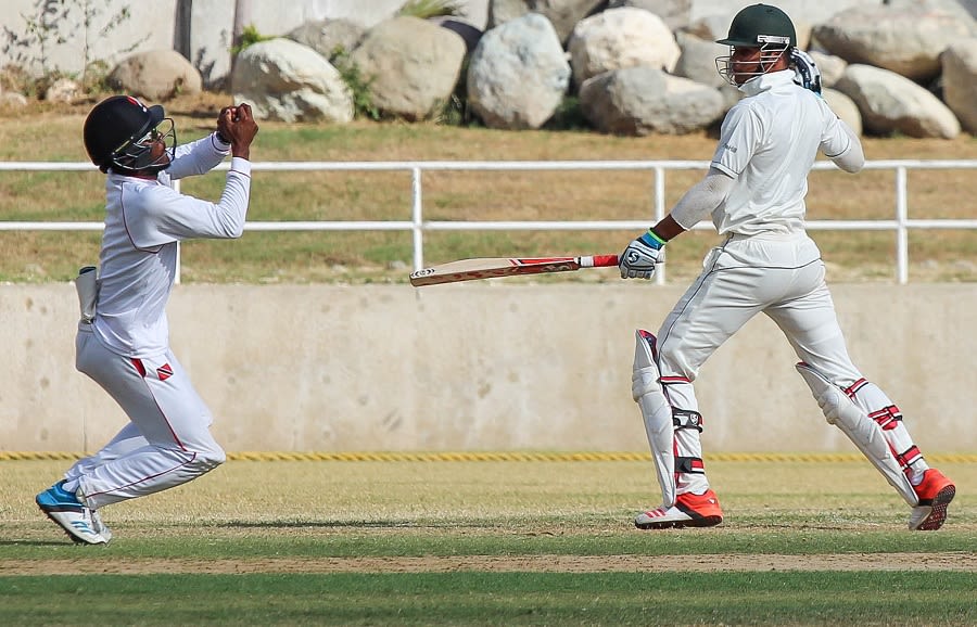 Yannick Ottley takes a catch to dismiss Brandon King