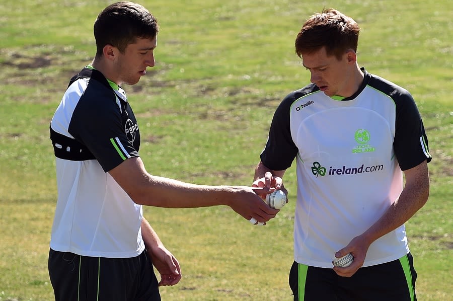 Peter Chase examines the bowling grip of Craig Young during training