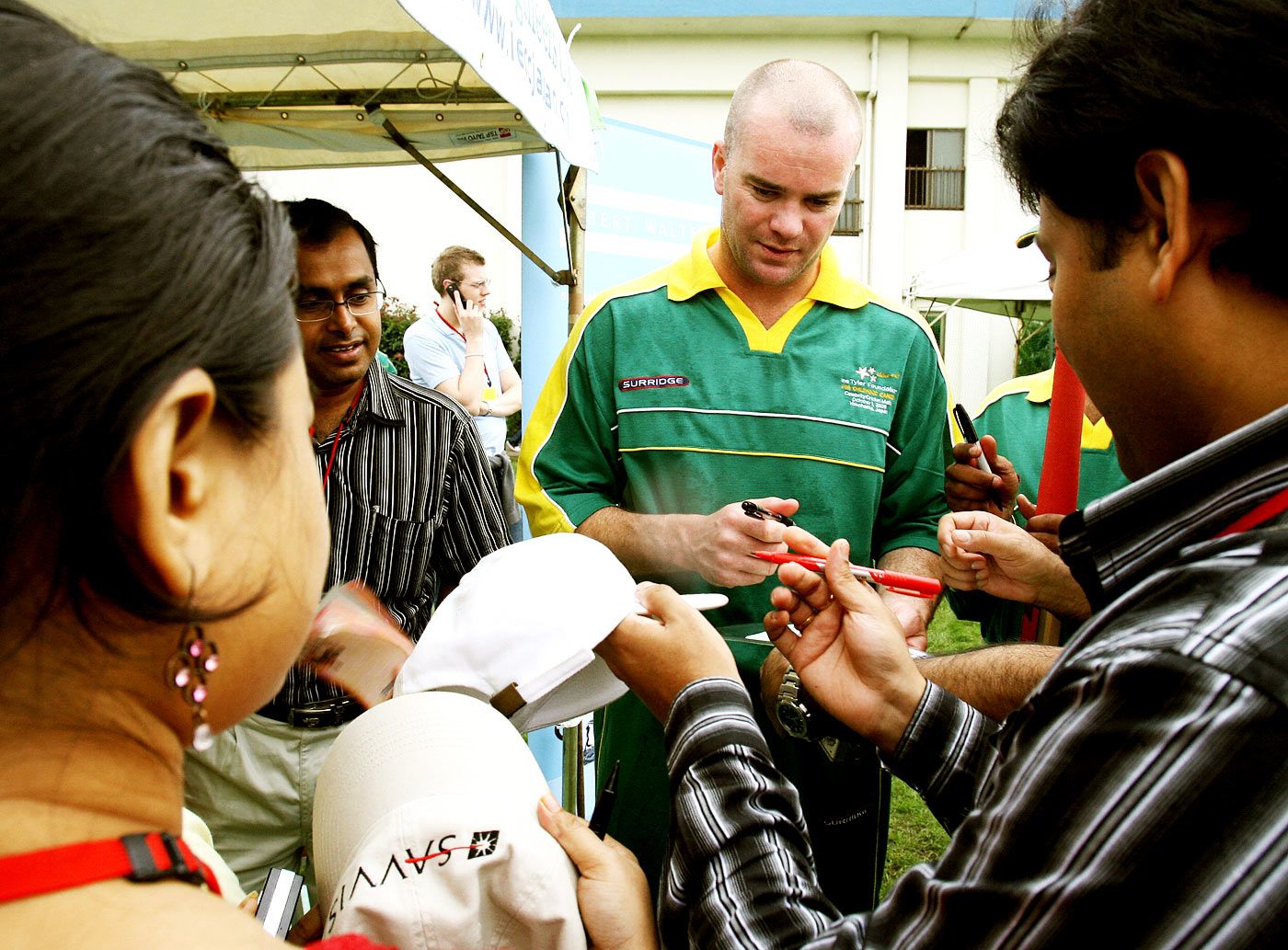 Dion Nash signs autographs for fans at a charity match in Yokohama
